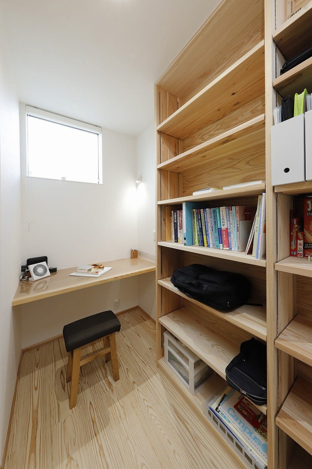 書斎は、手の届く範囲で色々と配置したいところです。
造作建具のデスクと収納で使い勝手も抜群。天井まである収納は自分で高さを変えられます。
窓からは明るい光が差し込み、昼間は電気が要らないほど。
家族を気にせず、集中できる書斎です。