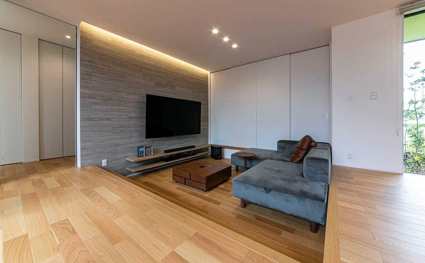 ゆったりと落ち着けるピットリビング。テレビモニターの背後の壁はエコカラットを採用